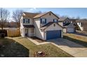Charming two-story home with a driveway, blue shutters, and a well-maintained lawn at 10725 Chenille Ct, Indianapolis, IN 46235