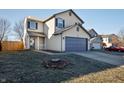 Two-story home with a well-manicured lawn and a two-car attached garage at 10725 Chenille Ct, Indianapolis, IN 46235