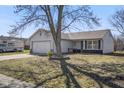 Well-maintained one-story home with a tidy lawn and mature tree in the front yard at 119 Karrington Blvd, Mooresville, IN 46158