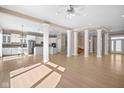 Spacious open-concept living area with decorative columns, light wood floors and abundant natural light at 12067 Edgefield Dr, Fishers, IN 46037
