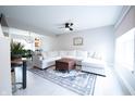 Bright living room featuring a large sectional sofa, modern decor, and light, wood-look floors at 12128 Princewood Ct, Fishers, IN 46037