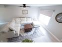 Bright living room featuring a large sectional sofa, modern decor, and light, wood-look floors at 12128 Princewood Ct, Fishers, IN 46037