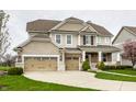 Charming two-story home with a three-car garage and manicured lawn at 12624 Teaberry Ln, Carmel, IN 46032