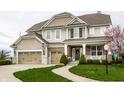 Charming two-story home with a three-car garage and manicured lawn at 12624 Teaberry Ln, Carmel, IN 46032