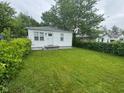 Well maintained single story home with a green lawn and mature shade trees at 1323 S Ewing St, Indianapolis, IN 46203