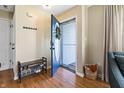 Welcoming foyer featuring hardwood floors, a shoe rack, and a decorative wreath on the door at 14055 Mimosa Ct, Fishers, IN 46038