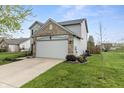 The side of a two-story home with siding and brick along with a two-car garage at 14055 Mimosa Ct, Fishers, IN 46038