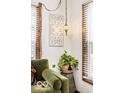 Cozy corner featuring a comfortable chair, decorative wall art, and a woven basket with a potted plant at 1647 N Tacoma Ave, Indianapolis, IN 46218
