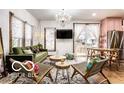 Bright living room with hardwood floors, a modern chandelier, and sliding doors leading to the outdoor space at 1647 N Tacoma Ave, Indianapolis, IN 46218