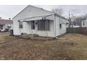 Cozy one story home with white siding and green awning detail over porch at 1843 Bauer Rd, Indianapolis, IN 46218