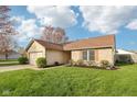 Well-kept home featuring an attached garage, brick accents, and neatly landscaped front yard in a residential neighborhood at 2020 Cross Willow Ln, Indianapolis, IN 46239