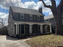Charming two-story home with a welcoming front porch, dark shutters and a beautifully maintained lawn at 207 Blue Ridge Rd, Indianapolis, IN 46208