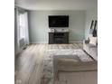 Living room featuring wood floors, a large TV, and modern decor at 2141 Galaxy Dr, Franklin, IN 46131