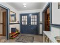 Entryway featuring double doors, neutral paint colors, and vinyl flooring at 2165 Plantation Ln, Martinsville, IN 46151