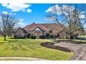 Stunning brick home with lush green lawn and mature trees creates a picturesque scene at 2605 Durbin Ct, Carmel, IN 46032