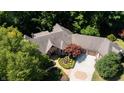 Overhead view of the home showcasing the roof, manicured landscaping, driveway, and surrounding lush greenery at 2688 S Oscar Ct, Morgantown, IN 46160