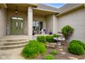 Charming front porch features a lovely water fountain and seating area, offering inviting curb appeal at 286 S Woodridge Dr, Pittsboro, IN 46167