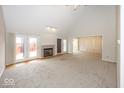 Spacious living room with a fireplace, high ceilings, and sliding doors leading to the deck at 2888 Prairie Stream Way, Columbus, IN 47203