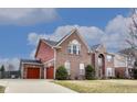Beautiful brick home featuring an attached garage with red doors and a well-maintained lawn at 3229 Autumn Ash Dr, Zionsville, IN 46077