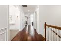 Bright hallway with hardwood floors and detailed molding leading to bedrooms and living areas at 3560 Cardinal Way, Carmel, IN 46074
