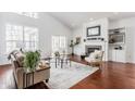 Open living room with large windows, vaulted ceilings and fireplace creates an airy atmosphere at 3560 Cardinal Way, Carmel, IN 46074
