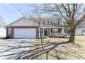 Charming two-story brick and vinyl home with a covered front porch and attached two-car garage at 3649 Homestead W Cir, Plainfield, IN 46168