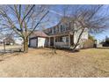 Two story brick and vinyl home with mature trees, covered front porch and attached two-car garage at 3649 Homestead W Cir, Plainfield, IN 46168