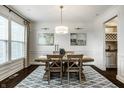Dining room showcasing hardwood floors, decorative rug, and modern lighting at 3905 Pelham Rd, Carmel, IN 46074