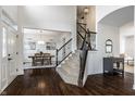 Spacious foyer with hardwood floors, staircase, and open view to dining room at 3905 Pelham Rd, Carmel, IN 46074