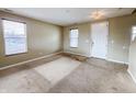 Cozy living room featuring two windows, neutral walls, a light fixture, and a welcoming front door at 3941 Planewood Dr, Indianapolis, IN 46235