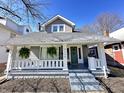 View of the front exterior of the home showcasing the porch and well-maintained landscaping at 4224 Cornelius Ave, Indianapolis, IN 46208