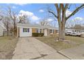 Inviting single-story brick home with a driveway and neatly kept lawn at 4457 N Kenmore Rd, Indianapolis, IN 46226
