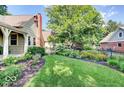 Beautifully landscaped backyard with green grass and colorful flower beds at 5055 Willow Rd, Zionsville, IN 46077