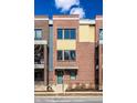 Exterior shot of a townhouse with a red brick facade, a front door, and large windows at 606 E 10Th St, Indianapolis, IN 46202