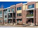 Street view of townhouses featuring private balconies with wrought iron, on a sunny day at 606 E 10Th St, Indianapolis, IN 46202