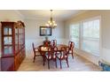 Dining room with a wood table, china cabinet, and a large window with natural light at 6481 W Treeline Ln, McCordsville, IN 46055