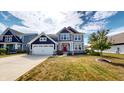 Beautiful two-story home with well-manicured lawn, navy and gray siding, and a red front door at 6481 W Treeline Ln, McCordsville, IN 46055