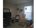 Comfortable bedroom featuring a desk, comfortable seating, and natural light from the window at 6610 Trey Ct, Camby, IN 46113