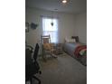 Cozy bedroom with a rocking chair, daybed, and a hanging plant by the window at 6610 Trey Ct, Camby, IN 46113