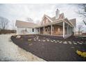 Charming home featuring a full front porch and landscaped garden beds, with a walkway to the house at 695 N 650 W, Lebanon, IN 46052