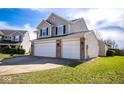 Spacious three-car garage with a well-manicured lawn, adding to the home's curb appeal at 7136 Allegan Dr, Indianapolis, IN 46217