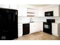 Modern kitchen with sleek black appliances and white cabinetry, creating a stylish culinary space at 7136 Allegan Dr, Indianapolis, IN 46217