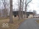 Traditional single-story home with a long driveway and mature trees in a quiet neighborhood at 7240 W Glendale Ln, Greenfield, IN 46140