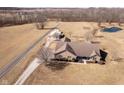 Aerial view of a brick home on a sprawling lot with pond and long driveway at 7260 N 225 W, Lebanon, IN 46052