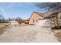 Property featuring an additional building with gravel driveway and spacious attached garage at 7260 N 225 W, Lebanon, IN 46052