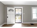 Bright entryway featuring an open door with security screen and natural light, hardwood floors at 766 N Bancroft St, Indianapolis, IN 46201