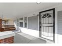 Inviting front porch with a swing and secure front door with black security door for peace of mind at 766 N Bancroft St, Indianapolis, IN 46201