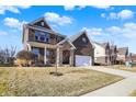 Traditional two-story home with brick and stone accents, showcasing a well-manicured front yard and driveway at 7800 Walker Cup Dr, Brownsburg, IN 46112