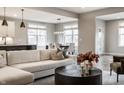 Bright and airy open floor plan with modern sofa, leading to the dining and kitchen areas at 804 Whispering Oaks Dr, Carmel, IN 46032