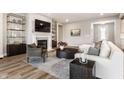 Comfortable living room showcasing a fireplace, large TV, stylish seating, and modern decor at 804 Whispering Oaks Dr, Carmel, IN 46032